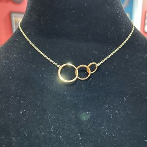 Gold tone triple circle adjustable necklace. Total length 17”